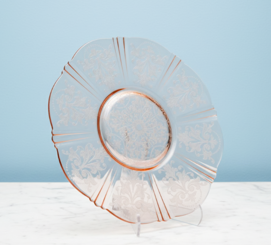Decorative vintage macbeth evaans glass plate with rose gold rim on a light blue background
